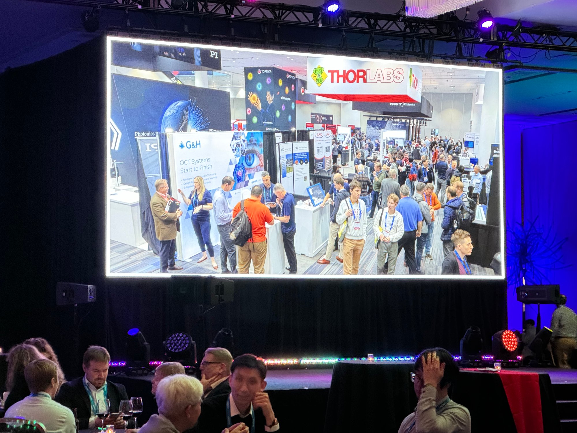 G&H BiOS 2024 space at Photonics West Day 1 party on the big screen